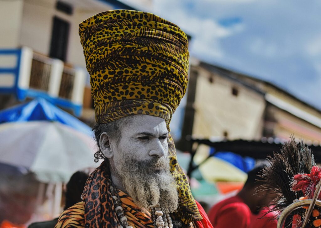 A vibrant portrait of a Sadhu with a painted face and turban in Kedarnath, India.