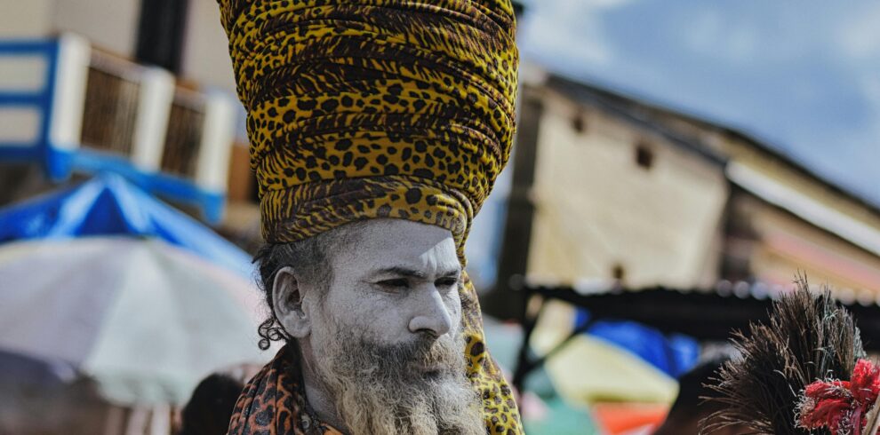 A vibrant portrait of a Sadhu with a painted face and turban in Kedarnath, India.